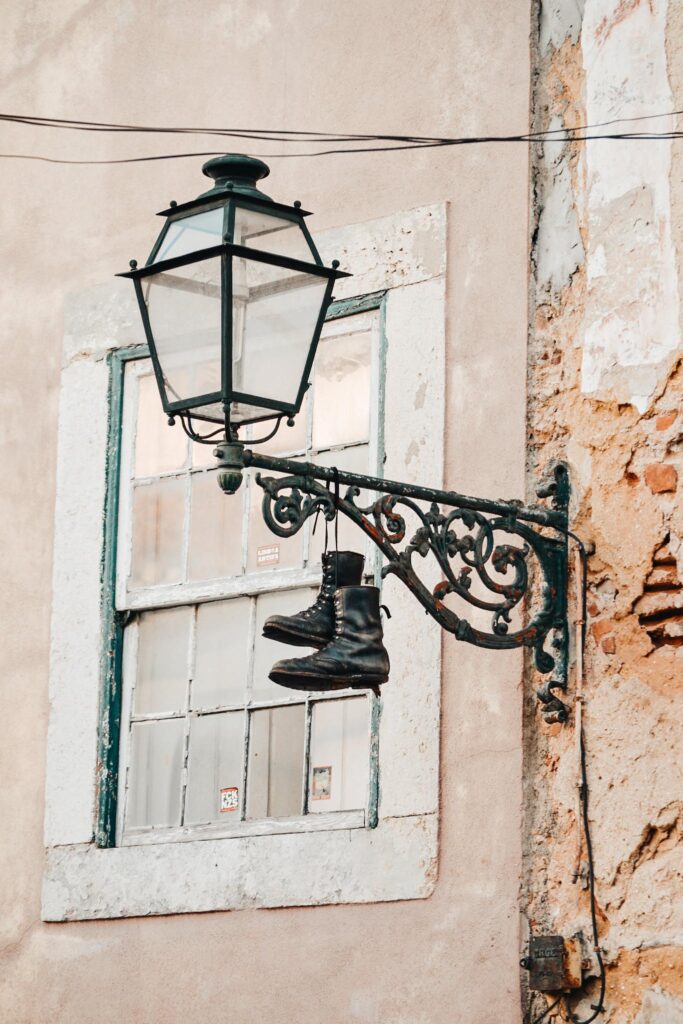 Pair of Leather Boots Hanging on Sconce