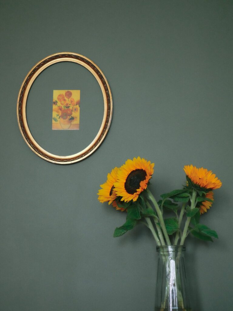 Vase with yellow sunflowers on table