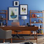 Brown Wooden Desk With Rolling Chair and Shelves Near Window