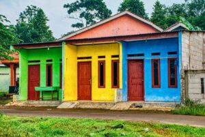 Vibrant multicolored houses with wooden doors in Banten, Indonesia.